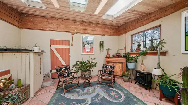a living room with furniture fireplace and a large window