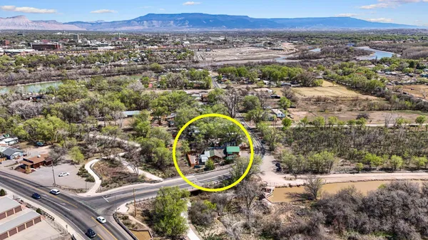 an aerial view of a house with a yard and lake view