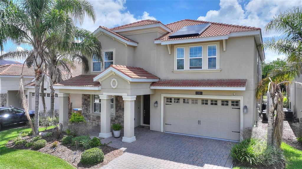 1089 Blackwolf Run Road Davenport, FL 33896 - Photo 4 of 82 a front view of a house with garden