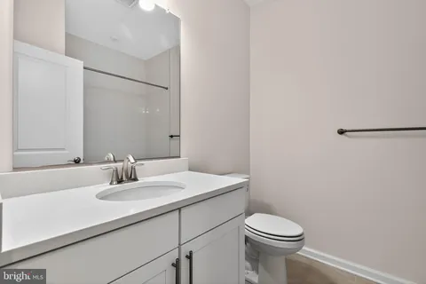 a bathroom with a sink toilet and mirror