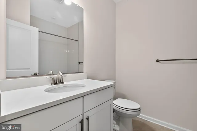 a bathroom with a sink toilet and mirror