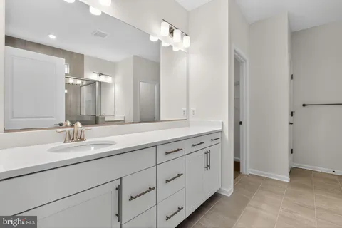 a bathroom with a double vanity sink and a mirror