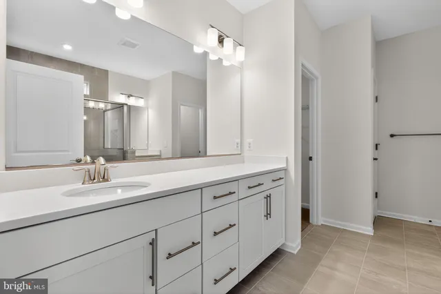 a bathroom with a double vanity sink and a mirror