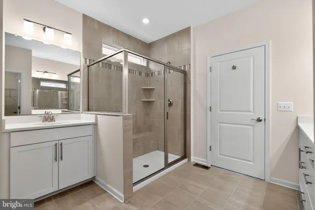 a bathroom with a shower sink and mirror
