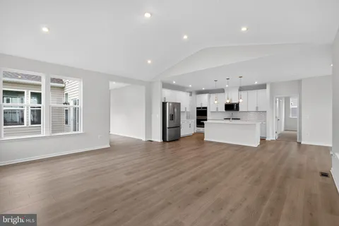 a view of kitchen with wooden floor and windows