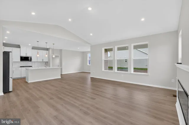 a view of kitchen with wooden floor and windows