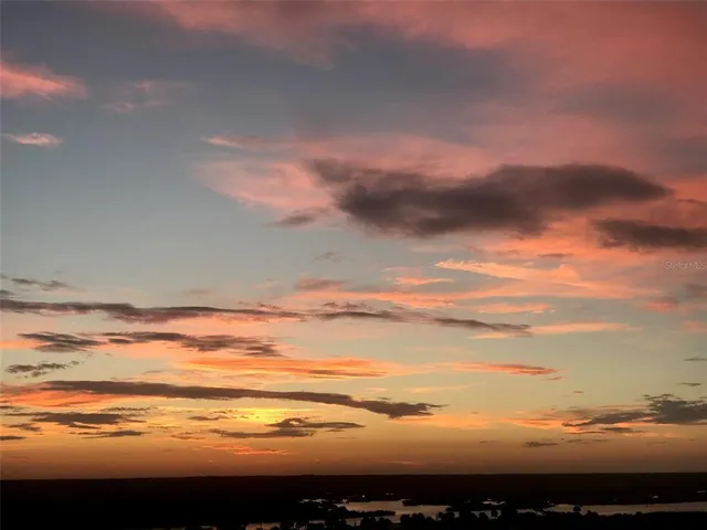 a bedroom with a bed and a floor to ceiling window