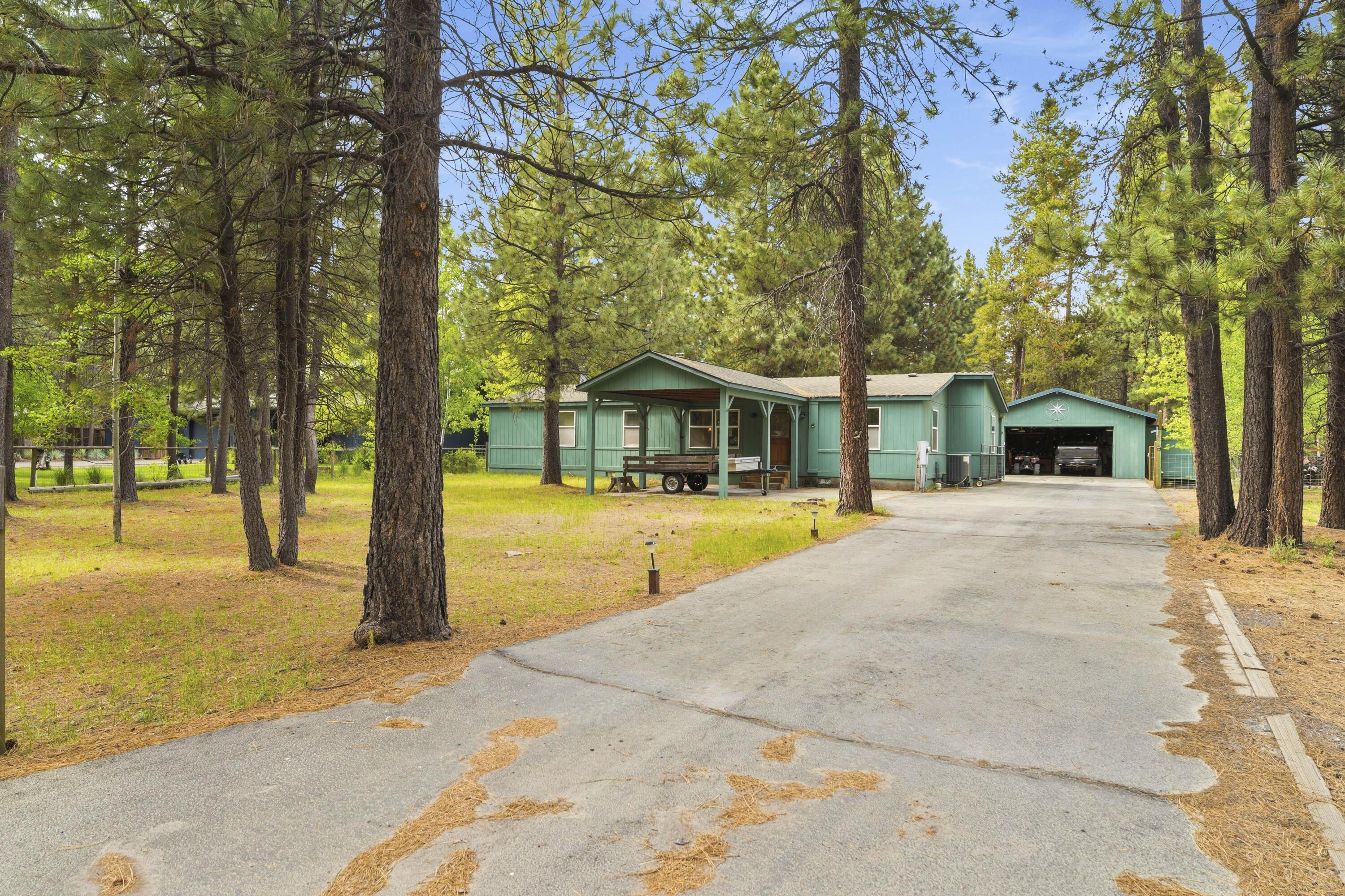 16928 Covina Road Bend, OR 97707 - Photo 41 of 48 a view of house with swimming pool outdoor seating and covered with trees