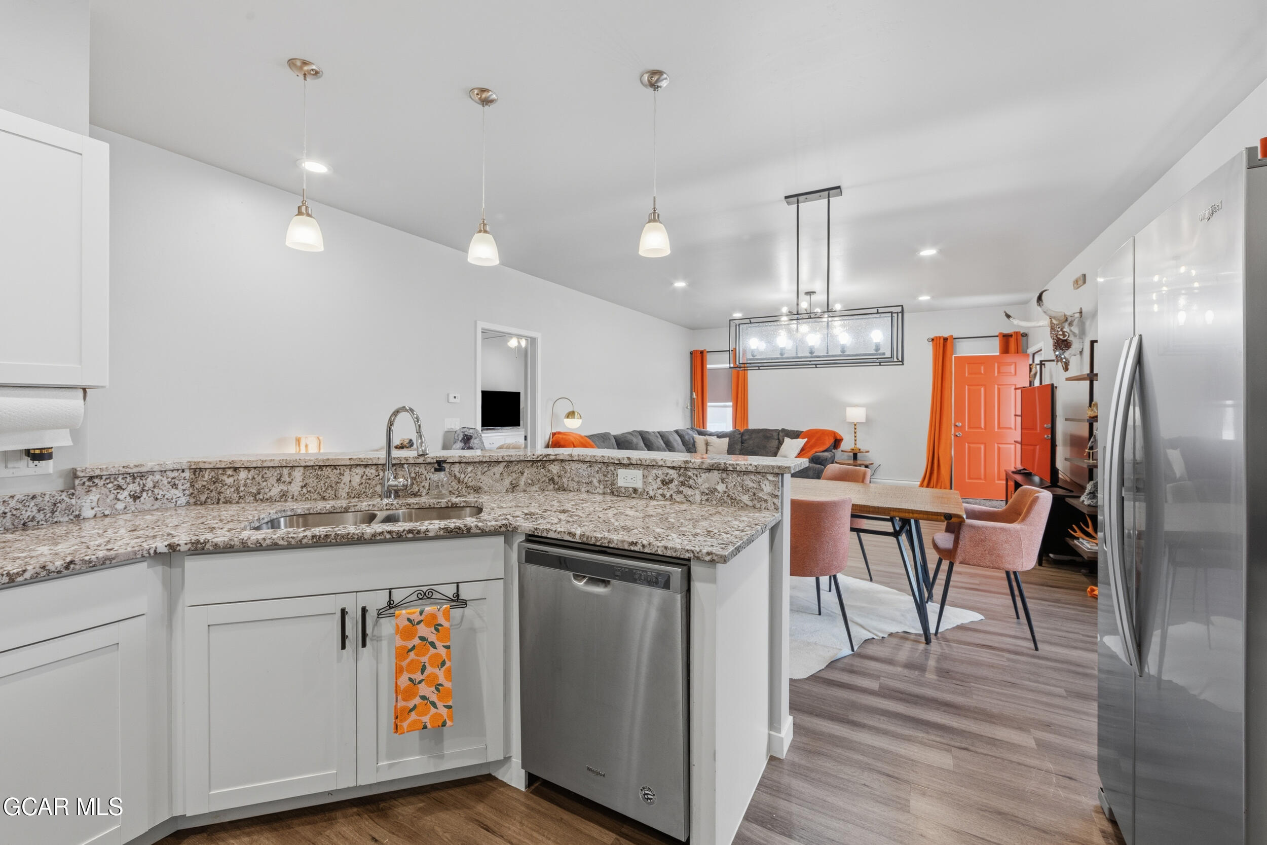 503 12th Street, Unit B Kremmling, CO 80459 - Photo 10 of 44 a kitchen with stainless steel appliances granite countertop a kitchen island a stove and a sink