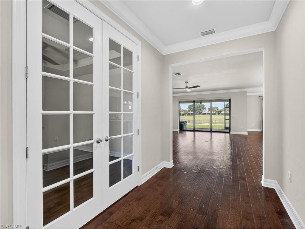 6124 Victory Drive Ave Maria, FL 34142 - Photo 24 of 50 a view of empty room with wooden floor and windows
