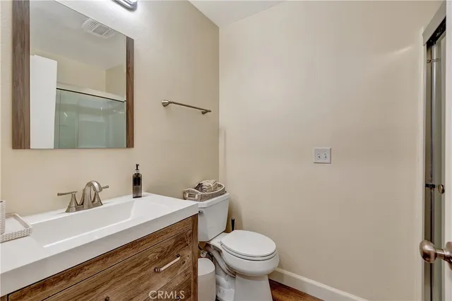 a bathroom with a sink toilet and mirror