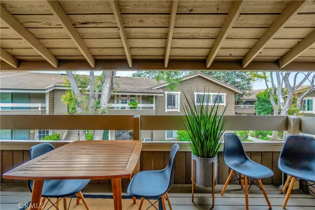 a view of a chairs and table in patio with a barbeque