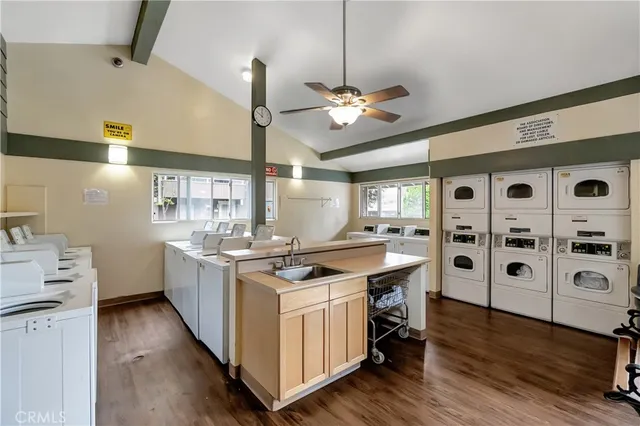 a kitchen with stainless steel appliances a stove a sink and a refrigerator