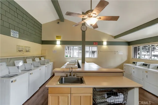 a kitchen with cabinets a sink and appliances