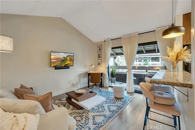 a living room with fireplace furniture and a floor to ceiling window