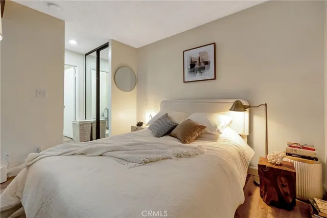 a bedroom with a bed and wooden floor