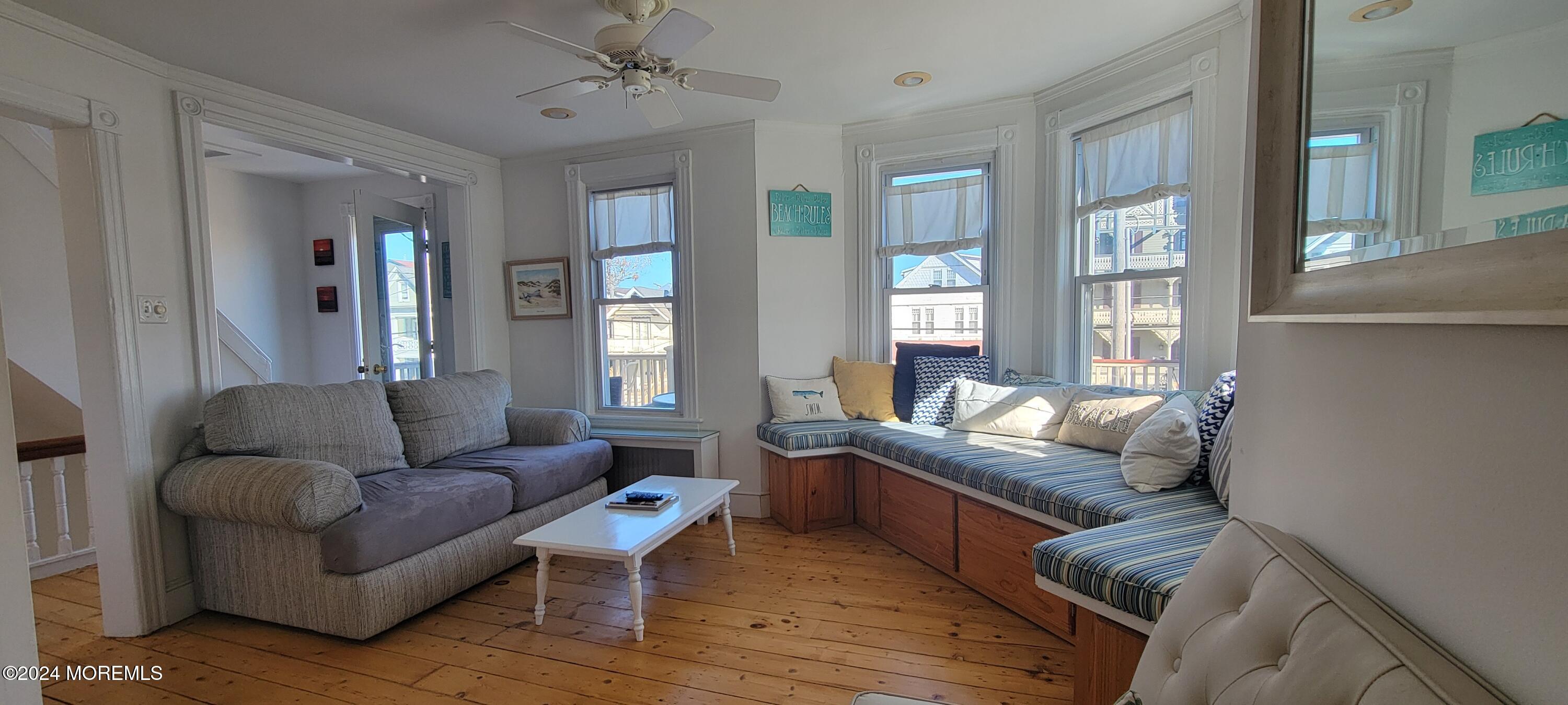 8 Surf Avenue, Unit 1 Ocean Grove, NJ 07756 - Photo 6 of 28 a living room with furniture and a large window