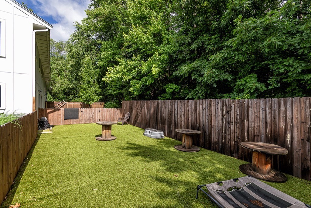 6 Twin Hills Farm Road, Unit 2 Rowley, MA 01969 - Photo 15 of 42 a view of a backyard with chairs potted plants and wooden fence