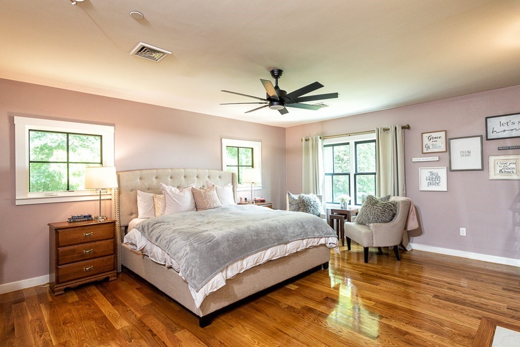 6 Twin Hills Farm Road, Unit 2 Rowley, MA 01969 - Photo 17 of 42 a bedroom with a bed and wooden floor