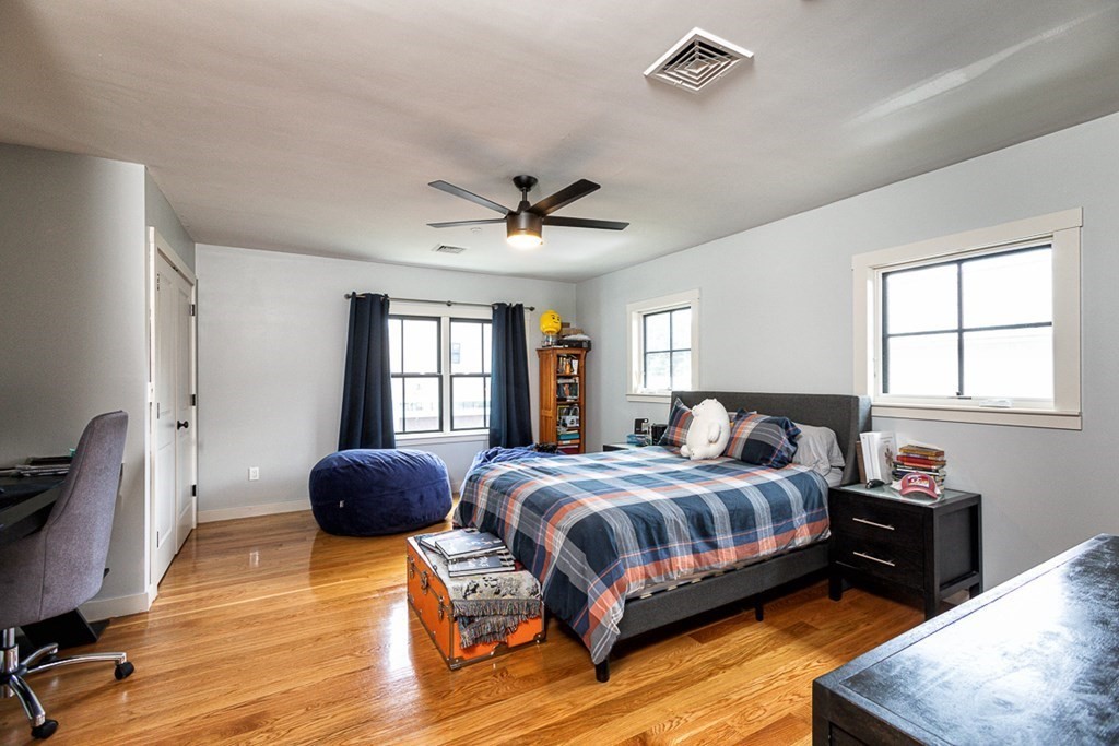 6 Twin Hills Farm Road, Unit 2 Rowley, MA 01969 - Photo 22 of 42 a bedroom with a bed and wooden floor