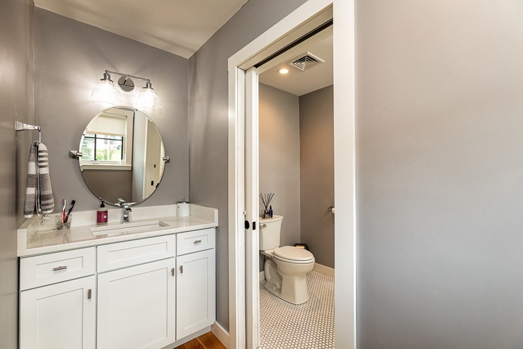 6 Twin Hills Farm Road, Unit 2 Rowley, MA 01969 - Photo 24 of 42 a bathroom with a toilet sink and mirror
