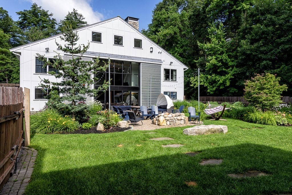 6 Twin Hills Farm Road, Unit 2 Rowley, MA 01969 - Photo 29 of 42 a front view of house with a garden and patio