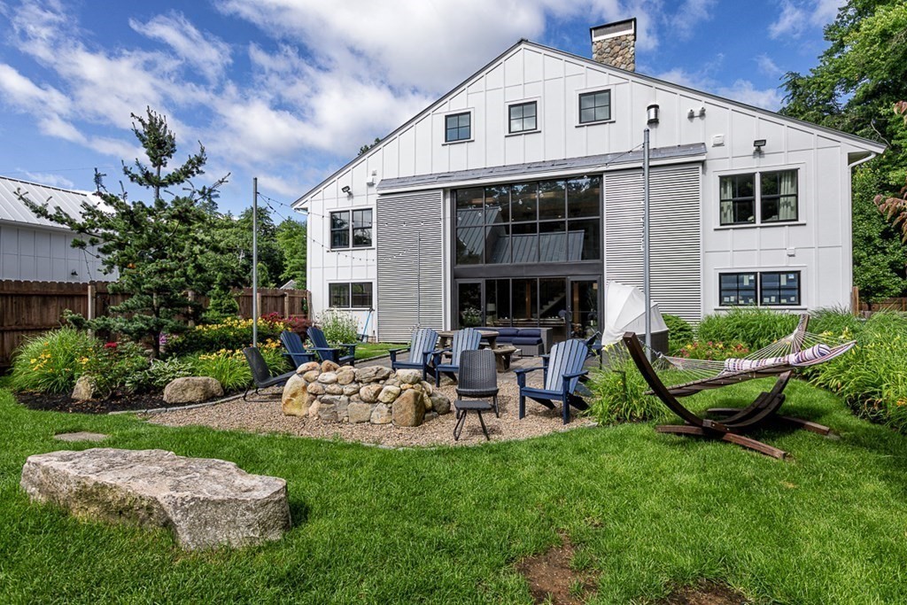 6 Twin Hills Farm Road, Unit 2 Rowley, MA 01969 - Photo 30 of 42 a view of a house with backyard sitting area and garden