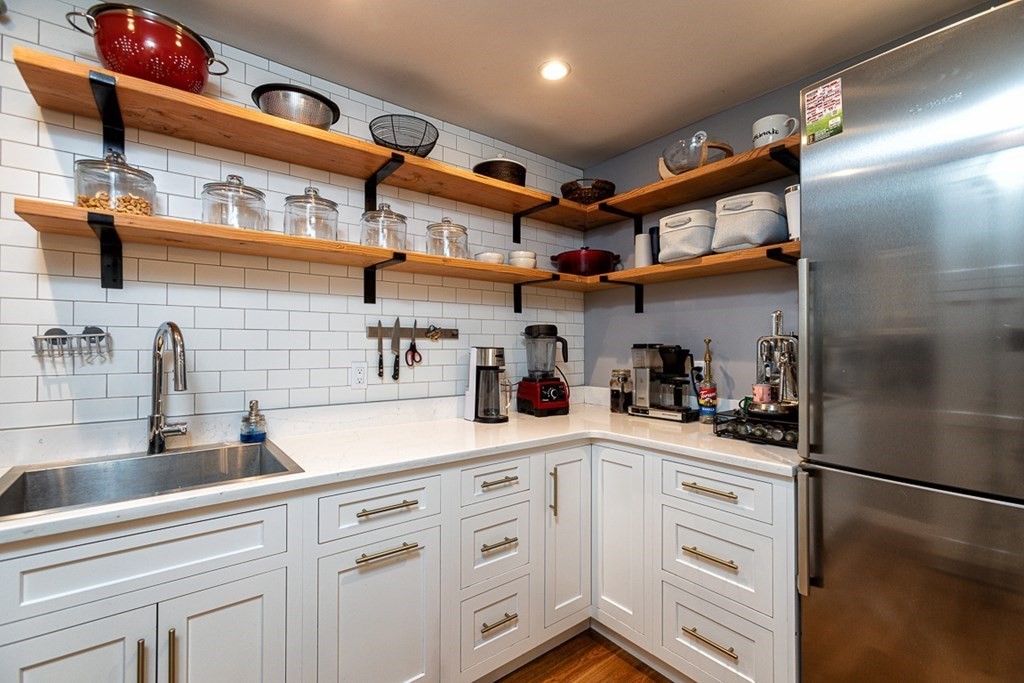 6 Twin Hills Farm Road, Unit 2 Rowley, MA 01969 - Photo 8 of 42 a kitchen with stainless steel appliances cabinets and a sink