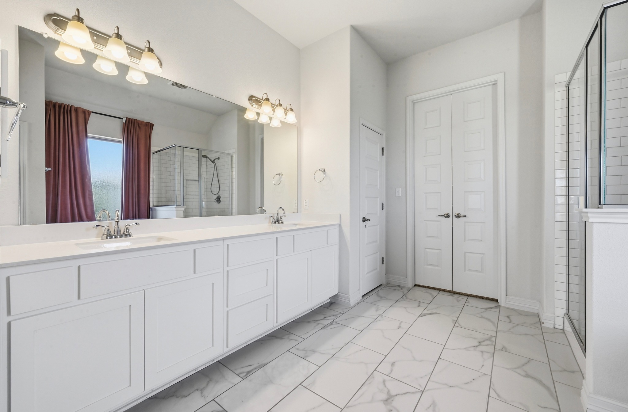 208 West Branch Road Kyle, TX 78640 - Photo 13 of 27 The primary ensuite features a dual vanity, walk-in shower and separate stand-alone tub.