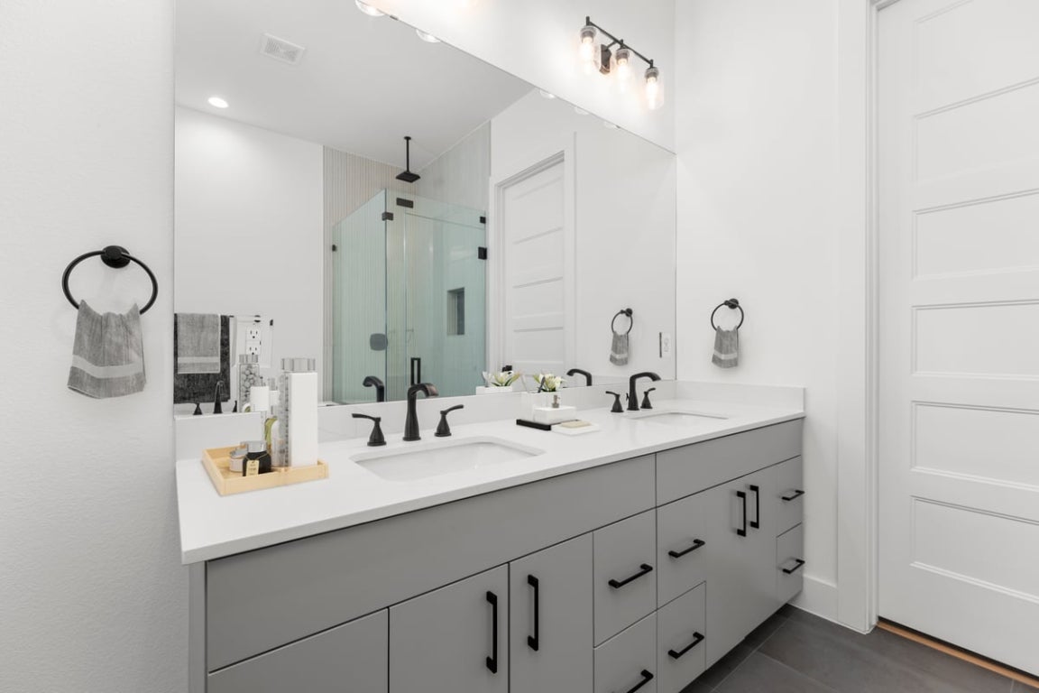 102 Mountain Home Road Horseshoe Bay, TX 78657 - Photo 12 of 32 a bathroom with double sink and a mirror