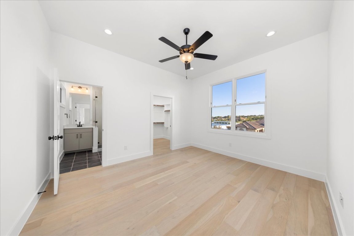 102 Mountain Home Road Horseshoe Bay, TX 78657 - Photo 16 of 32 wooden floor in an empty room and a cabinet