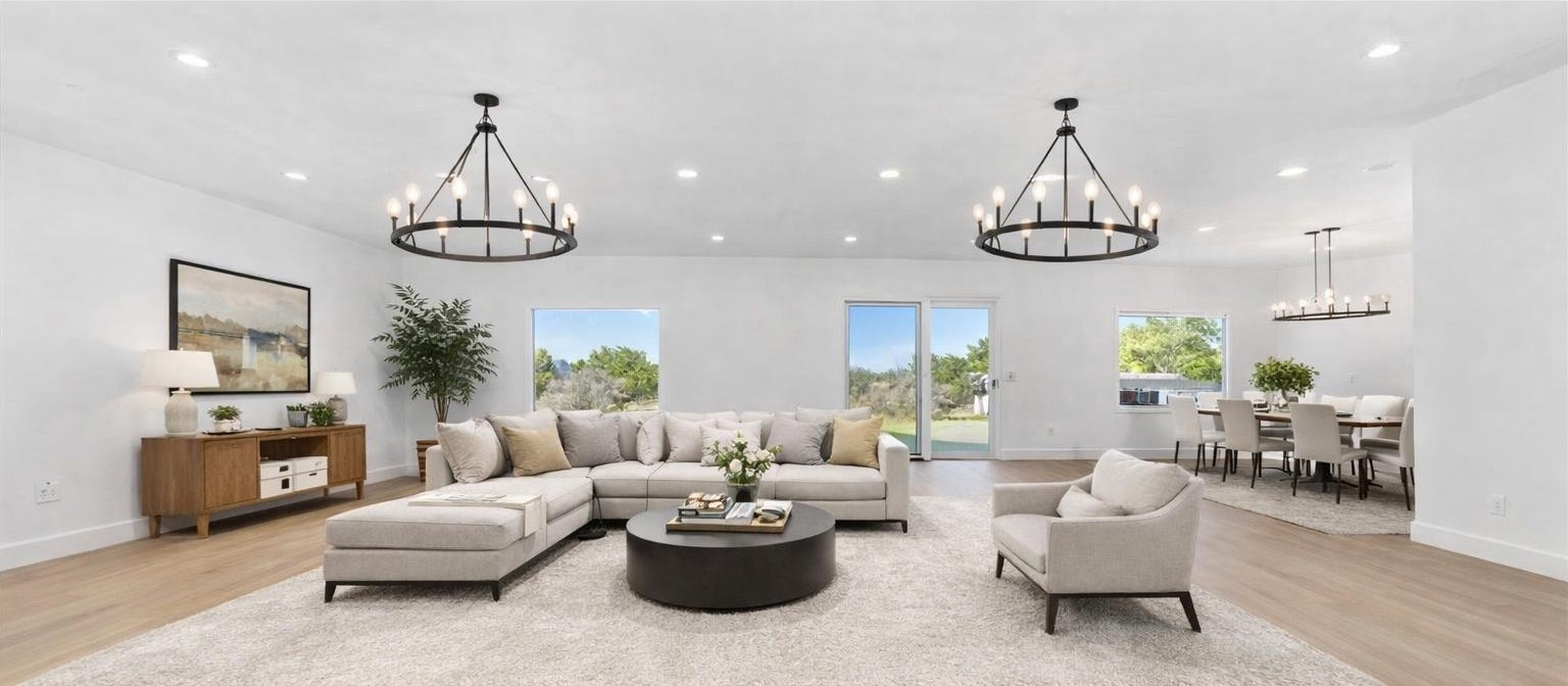 102 Mountain Home Road Horseshoe Bay, TX 78657 - Photo 5 of 32 a living room with furniture a chandelier a rug a fireplace and a chandelier