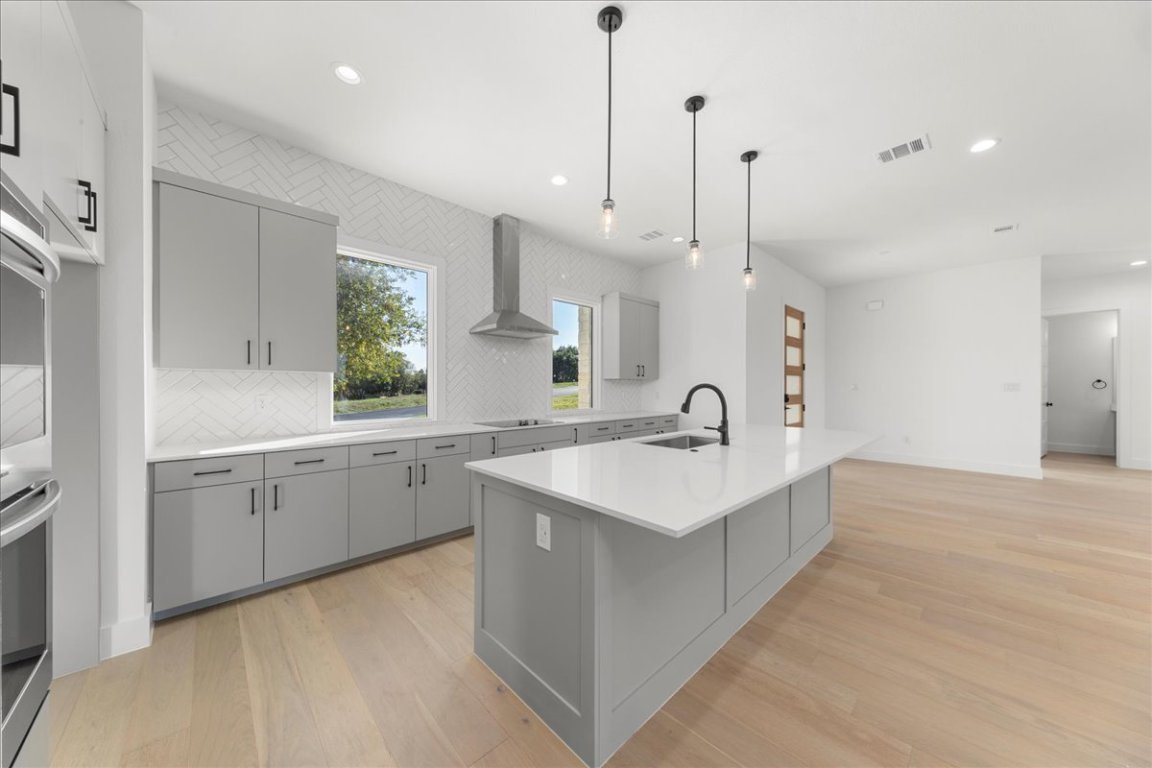 102 Mountain Home Road Horseshoe Bay, TX 78657 - Photo 9 of 32 a large white kitchen with a sink and a large window