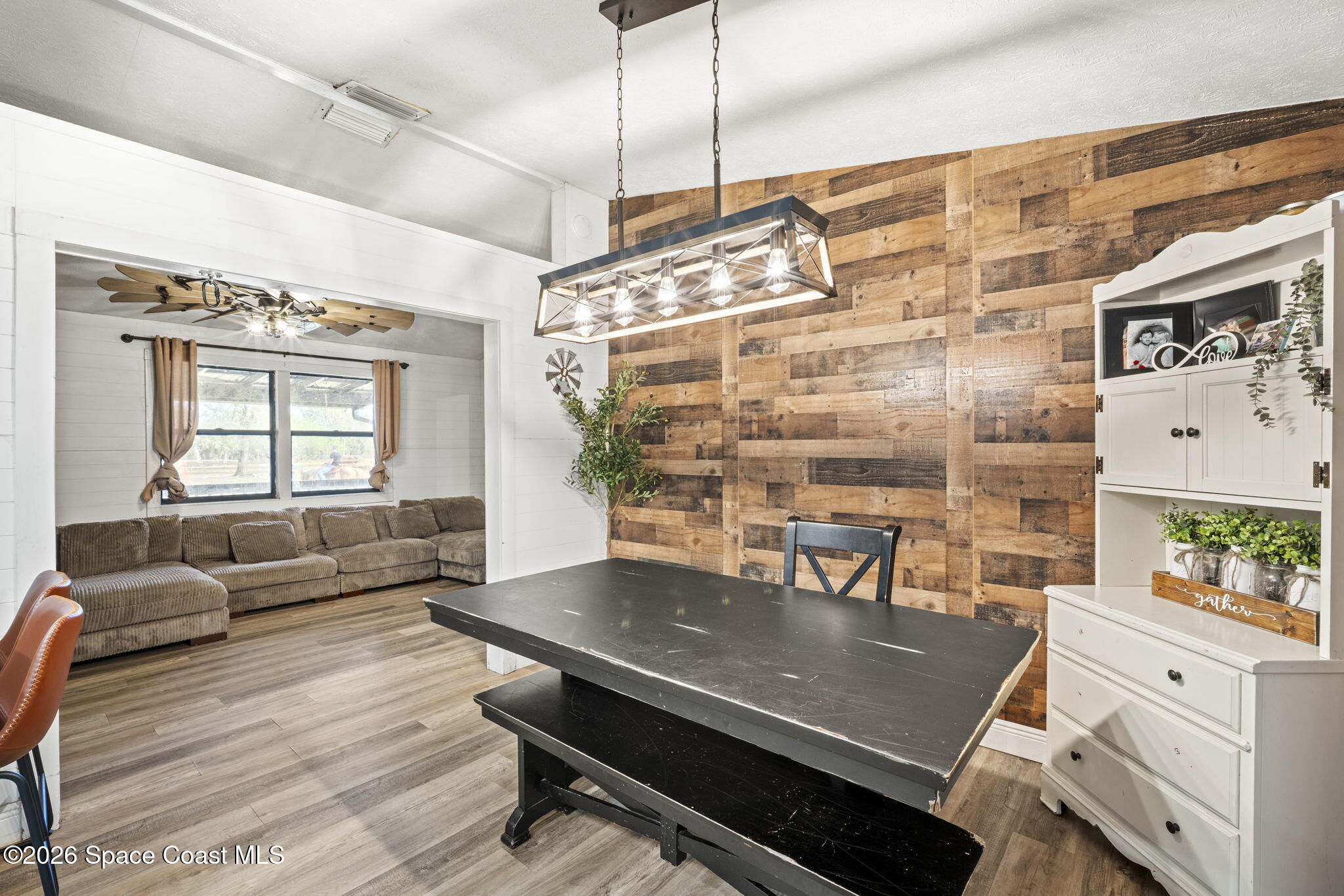 3416 Flounder Creek Road Mims, FL 32754 - Photo 11 of 42 a living room with furniture a table and wooden floor