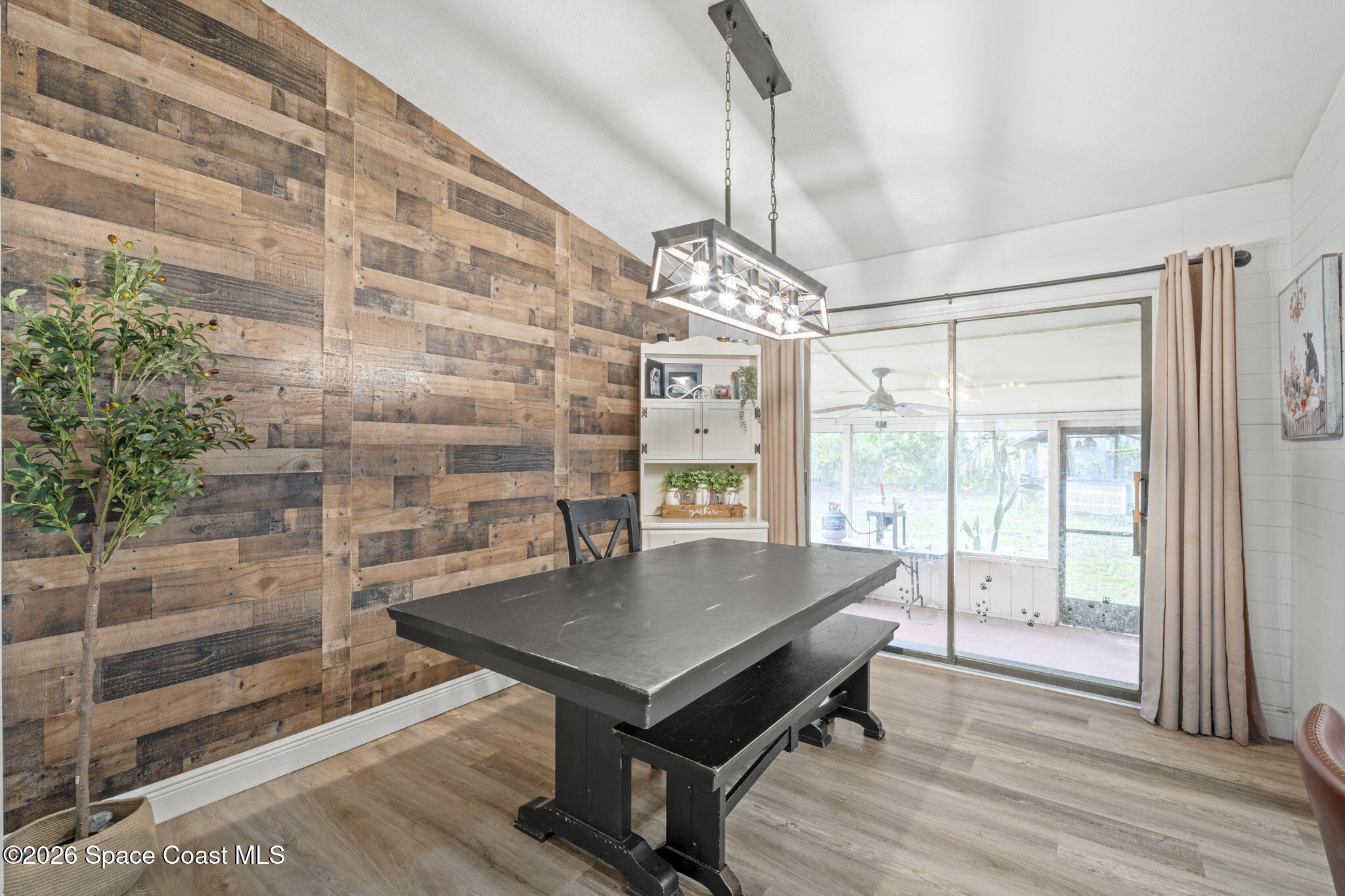 3416 Flounder Creek Road Mims, FL 32754 - Photo 12 of 42 a view of a dining room with furniture wooden floor and chandelier