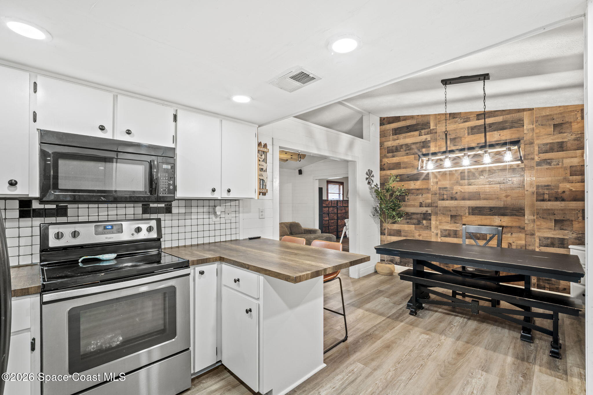3416 Flounder Creek Road Mims, FL 32754 - Photo 14 of 42 a kitchen with a stove a sink and a microwave