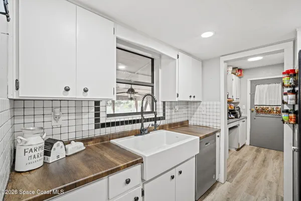 a kitchen with refrigerator cabinets and dining table