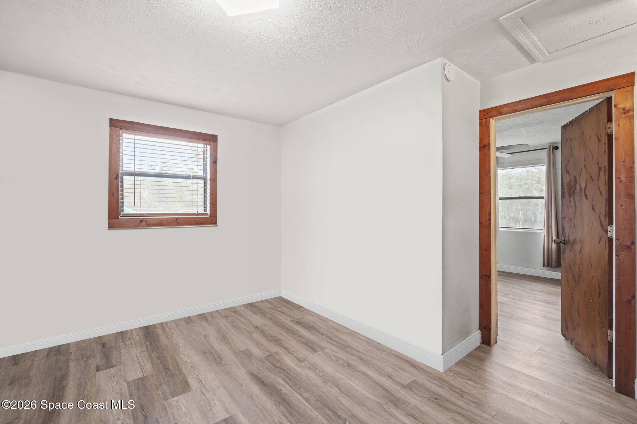 3416 Flounder Creek Road Mims, FL 32754 - Photo 20 of 42 an empty room with wooden floor closet and windows