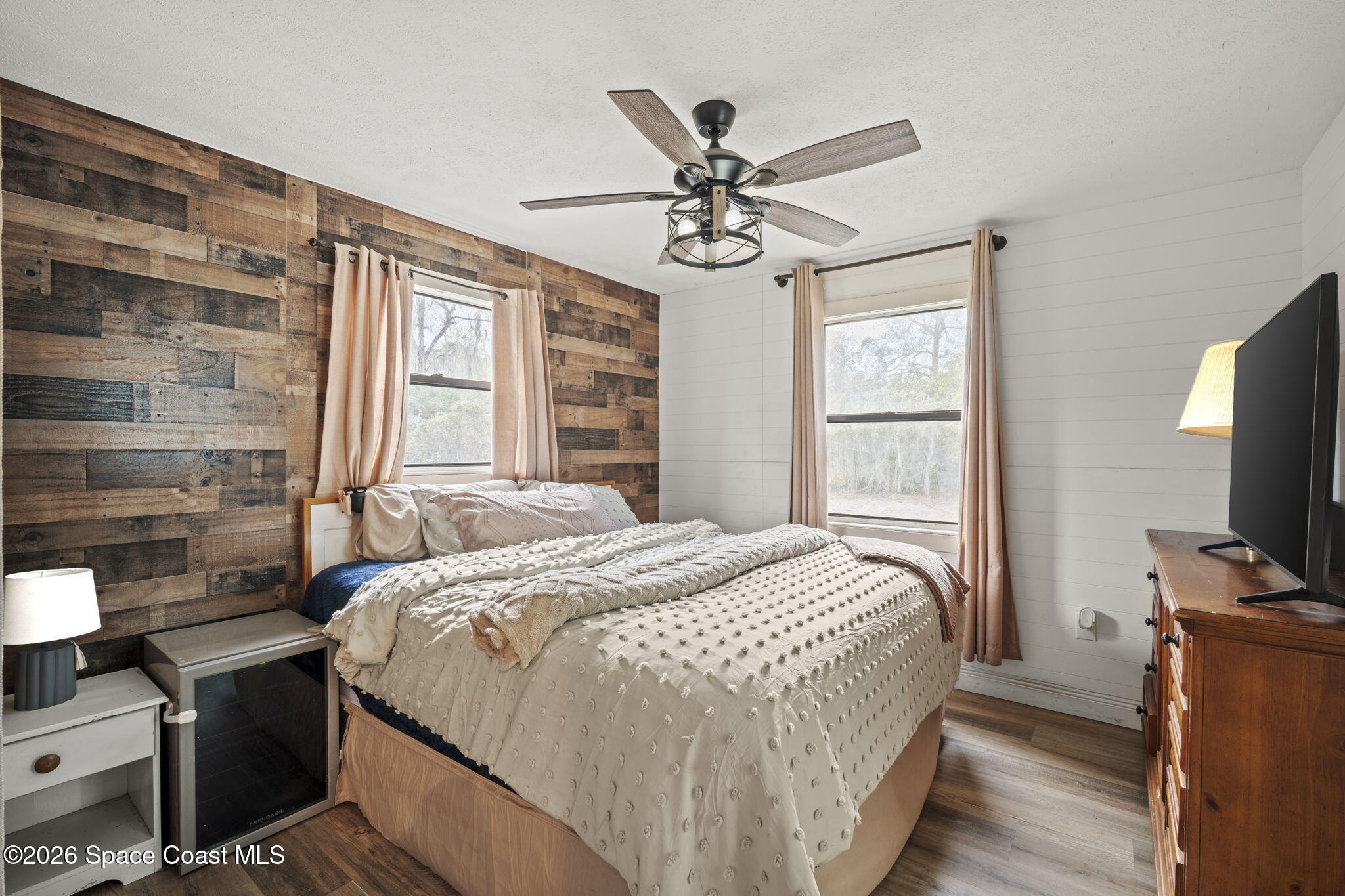 3416 Flounder Creek Road Mims, FL 32754 - Photo 21 of 42 a bedroom with a bed tv and a window