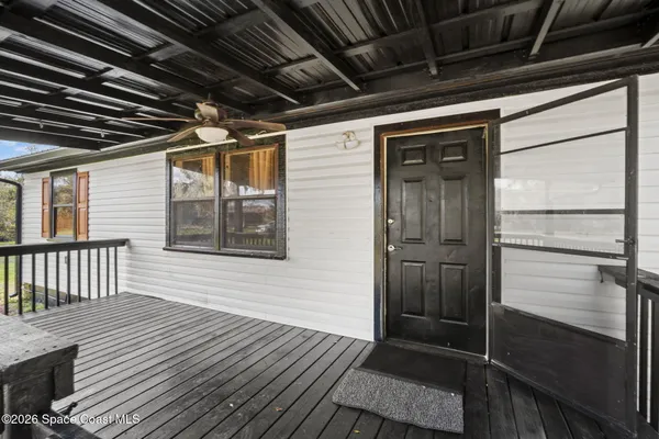 a view of a house with wooden deck