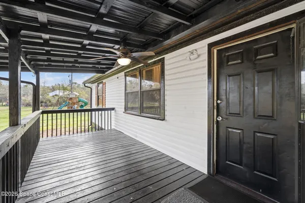 a view of a balcony with wooden floor
