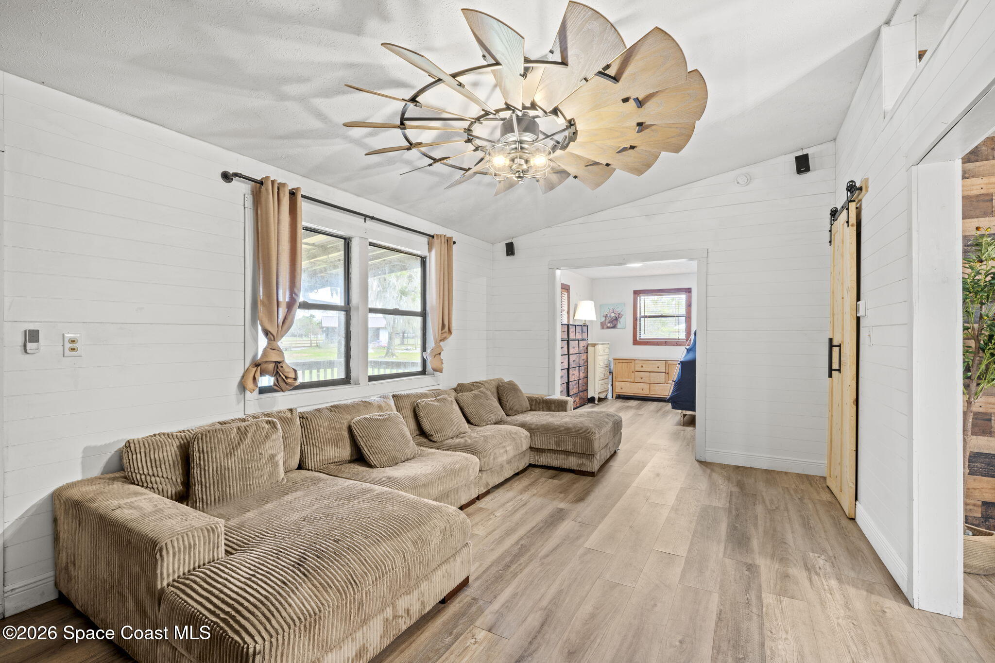 3416 Flounder Creek Road Mims, FL 32754 - Photo 8 of 42 a living room with furniture and a large window