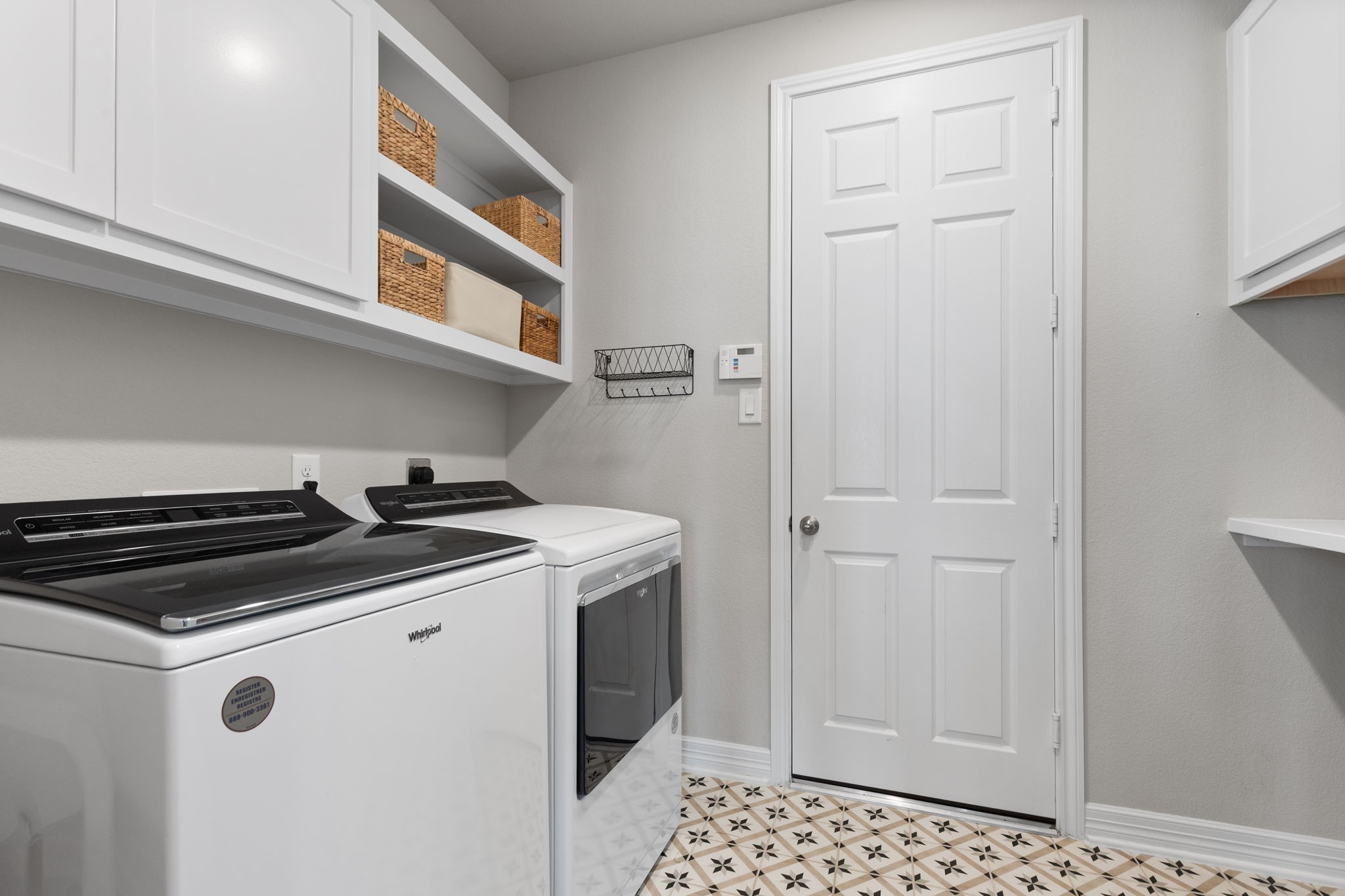 3541 Cherrybark Gable Ln Spring Spring, TX 77386 - Photo 11 of 39 Custom shelving and designer tiles in the laundry room.