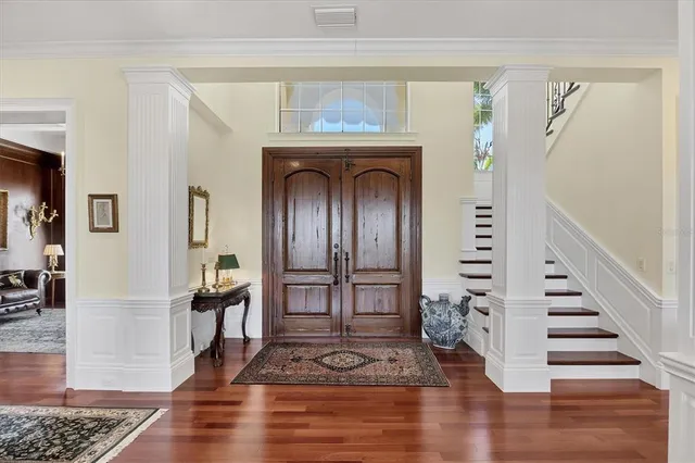 a living room with furniture a flat screen tv and kitchen view