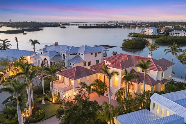 an aerial view of residential houses with outdoor space and lake view