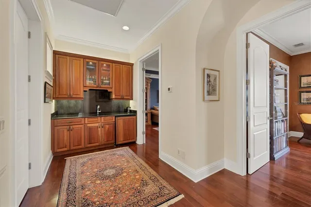 a bathroom with a granite countertop sink vanity mirror and toilet