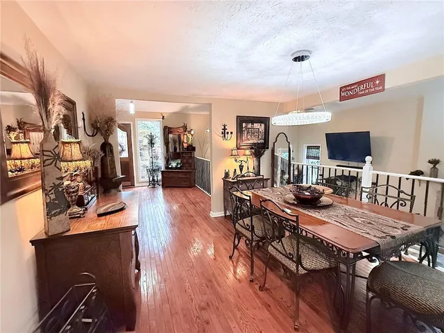 a view of a dining room with furniture and wooden floor