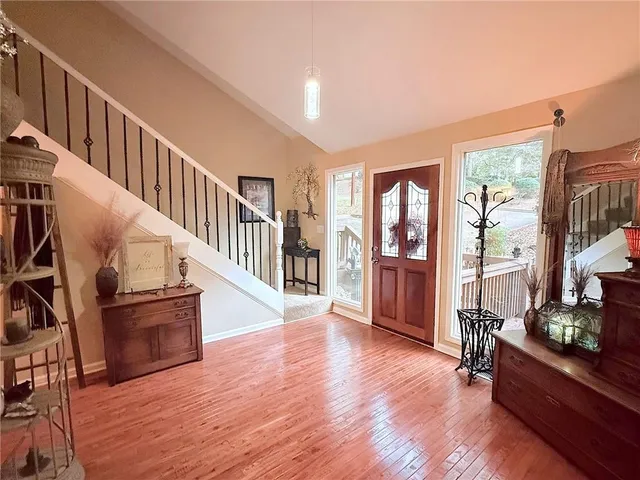 a view of entryway and hall with wooden floor