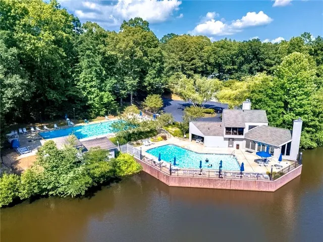 an aerial view of a house with a yard and lake view