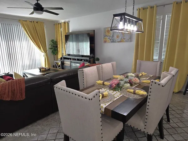 a dining room with furniture and wooden floor